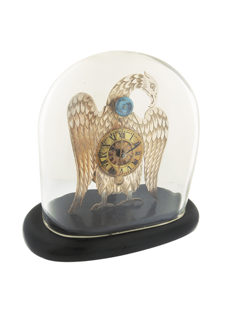 Viennese Eagle form case mounted on a wooden base with glazed dome