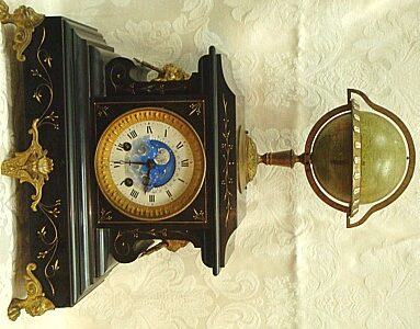 A Rare French Black Marble Mantel Clock With Revolving Globe and Moon Phases